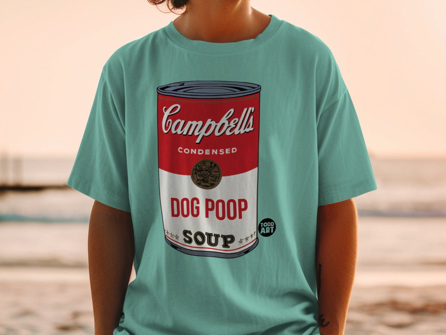 Teal t-shirt featuring Campbell's Condensed Soup label with "DOG POOP SOUP" text.