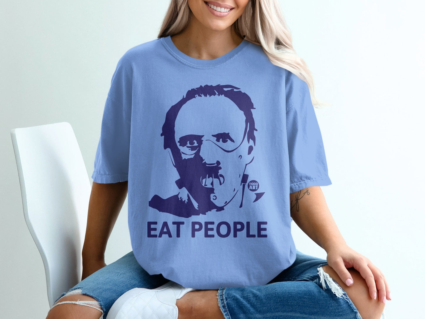 Blue t-shirt with "Eat People" text and a portrait graphic of a man.