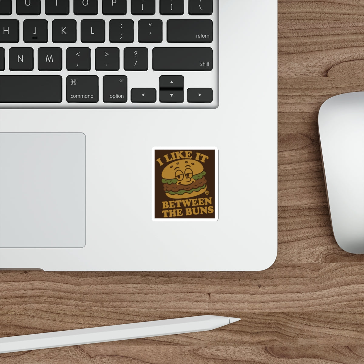 Sticker with cartoon burger saying "I like it between the buns".