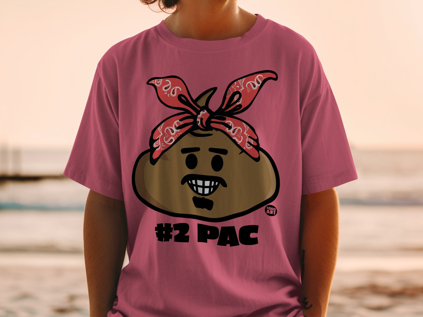 Pink t-shirt with a cartoon face wearing a bandana and the text "#2 PAC".