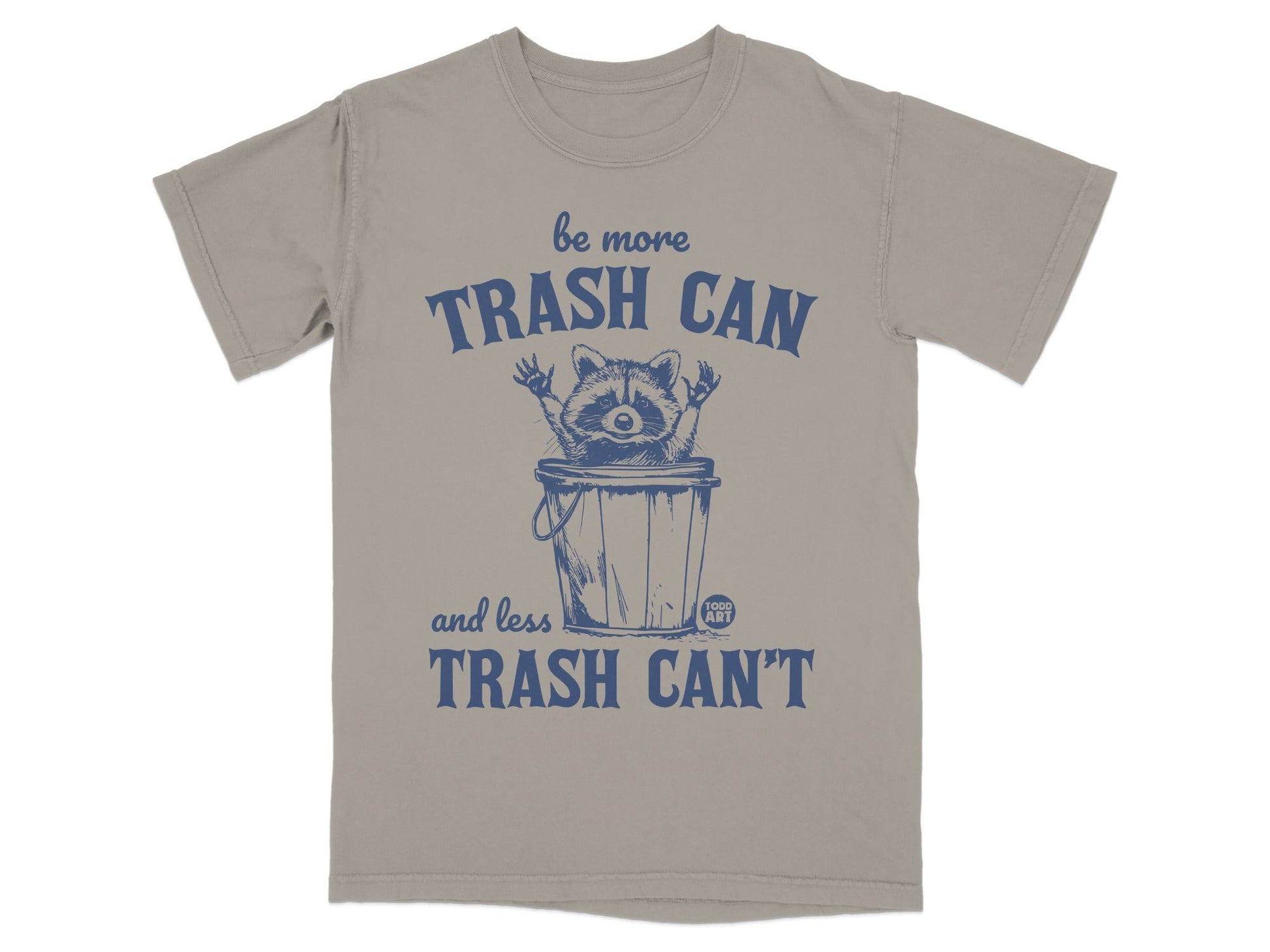 T-shirt graphic with raccoon in trash can, "be more trash can and less trash can't" text.
