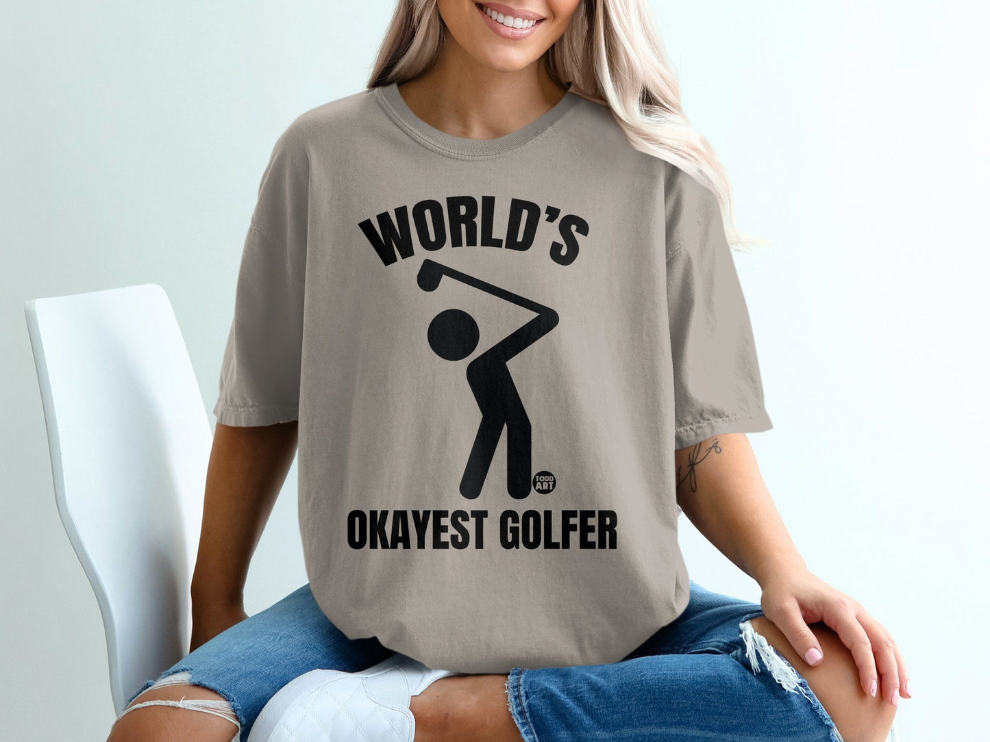 T-shirt with "World's Okayest Golfer" text and a golf silhouette.