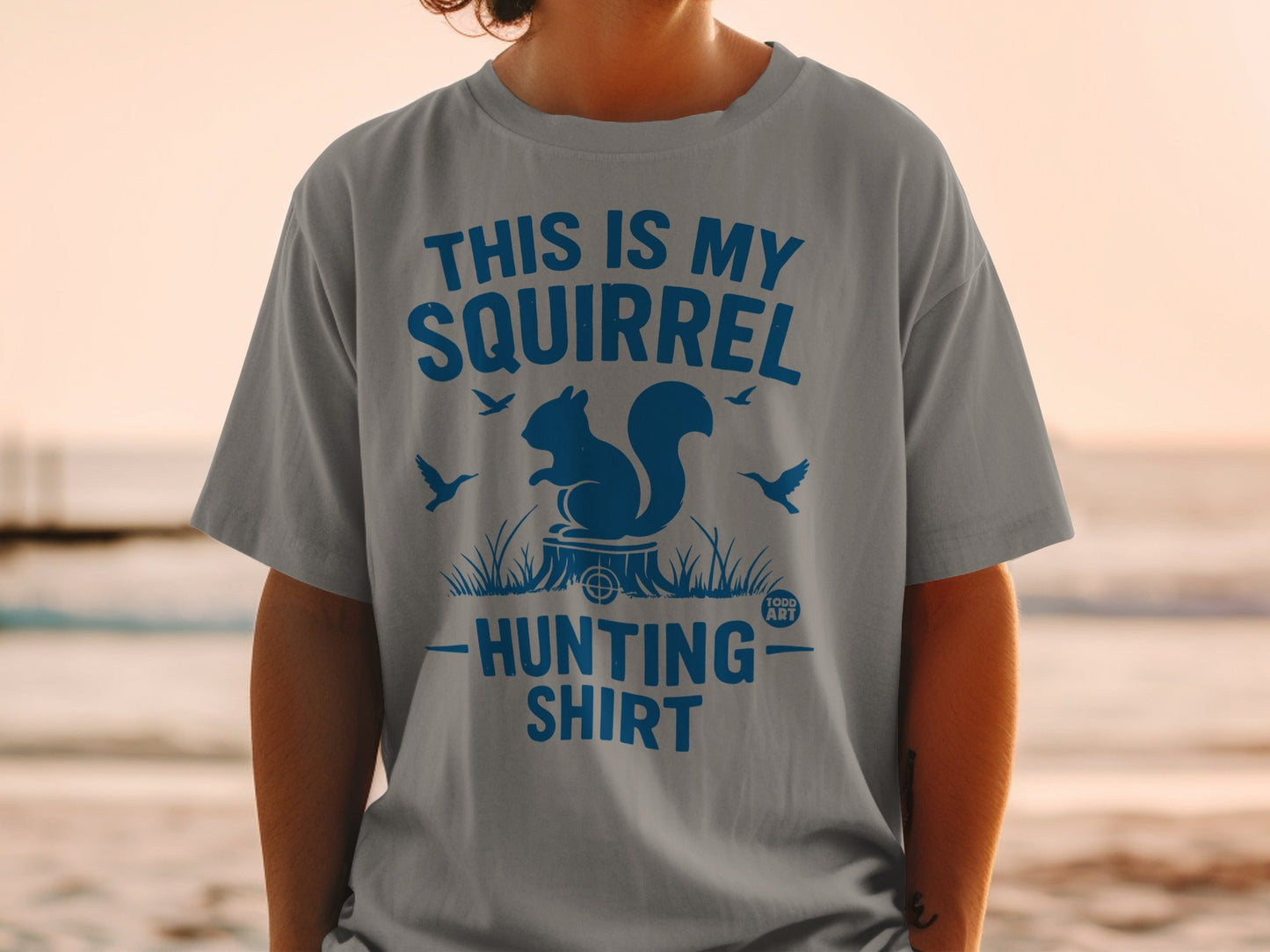 Gray t-shirt with blue text and squirrel illustration: "This is my squirrel hunting shirt."