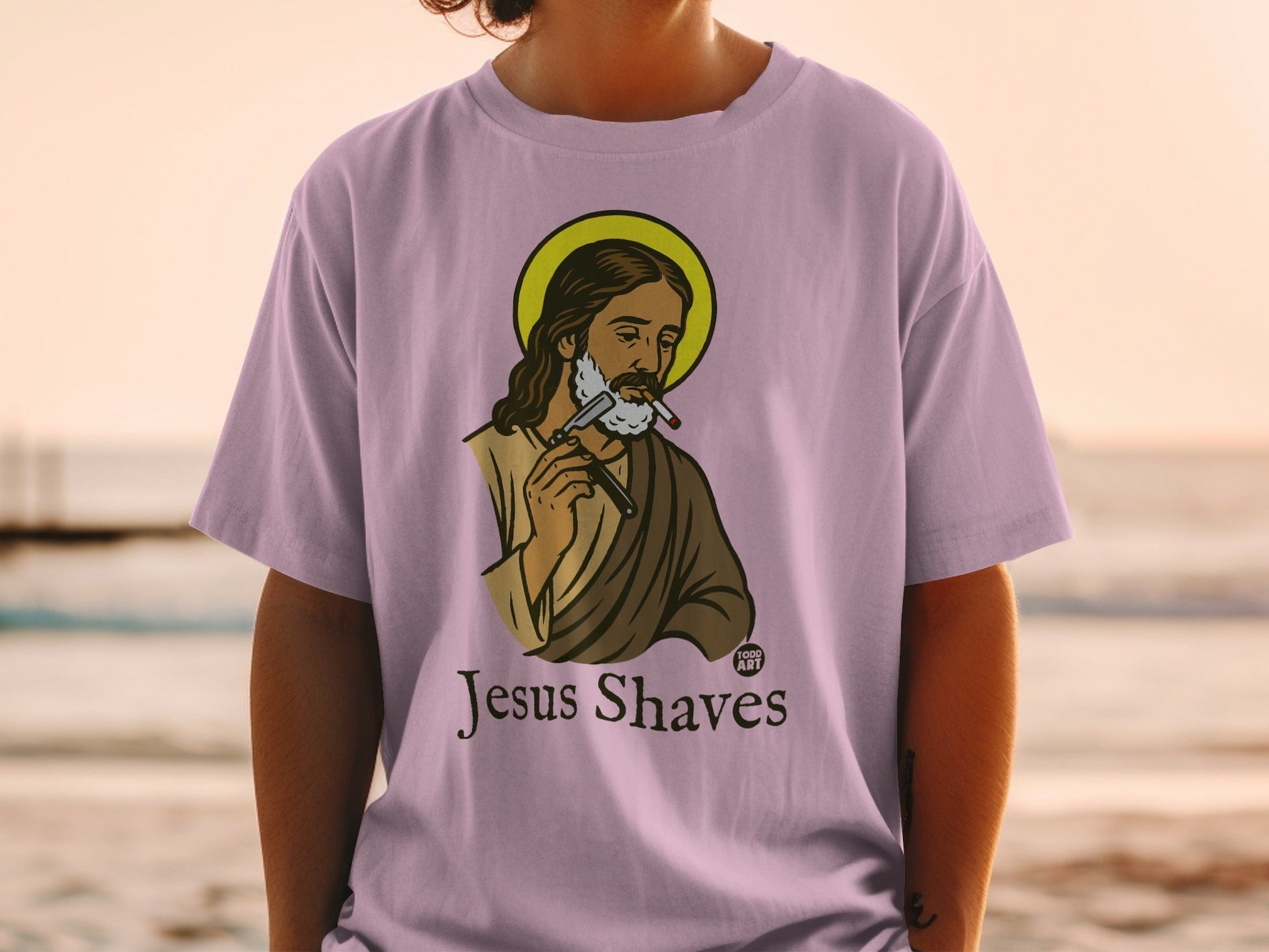 Jesus shaving his beard with a straight razor, text "Jesus Shaves".