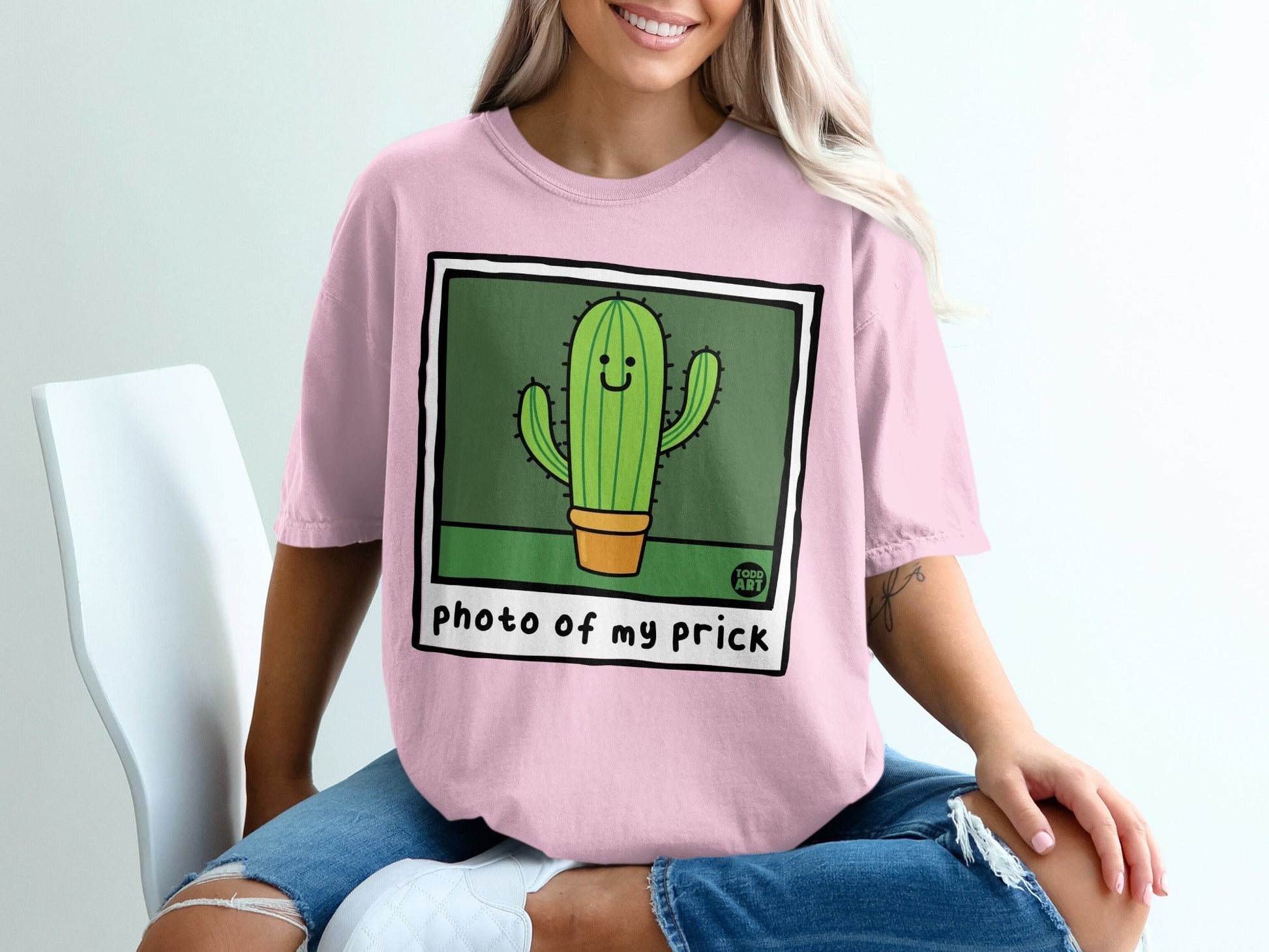 Pink t-shirt with cartoon cactus illustration and text "photo of my prick".