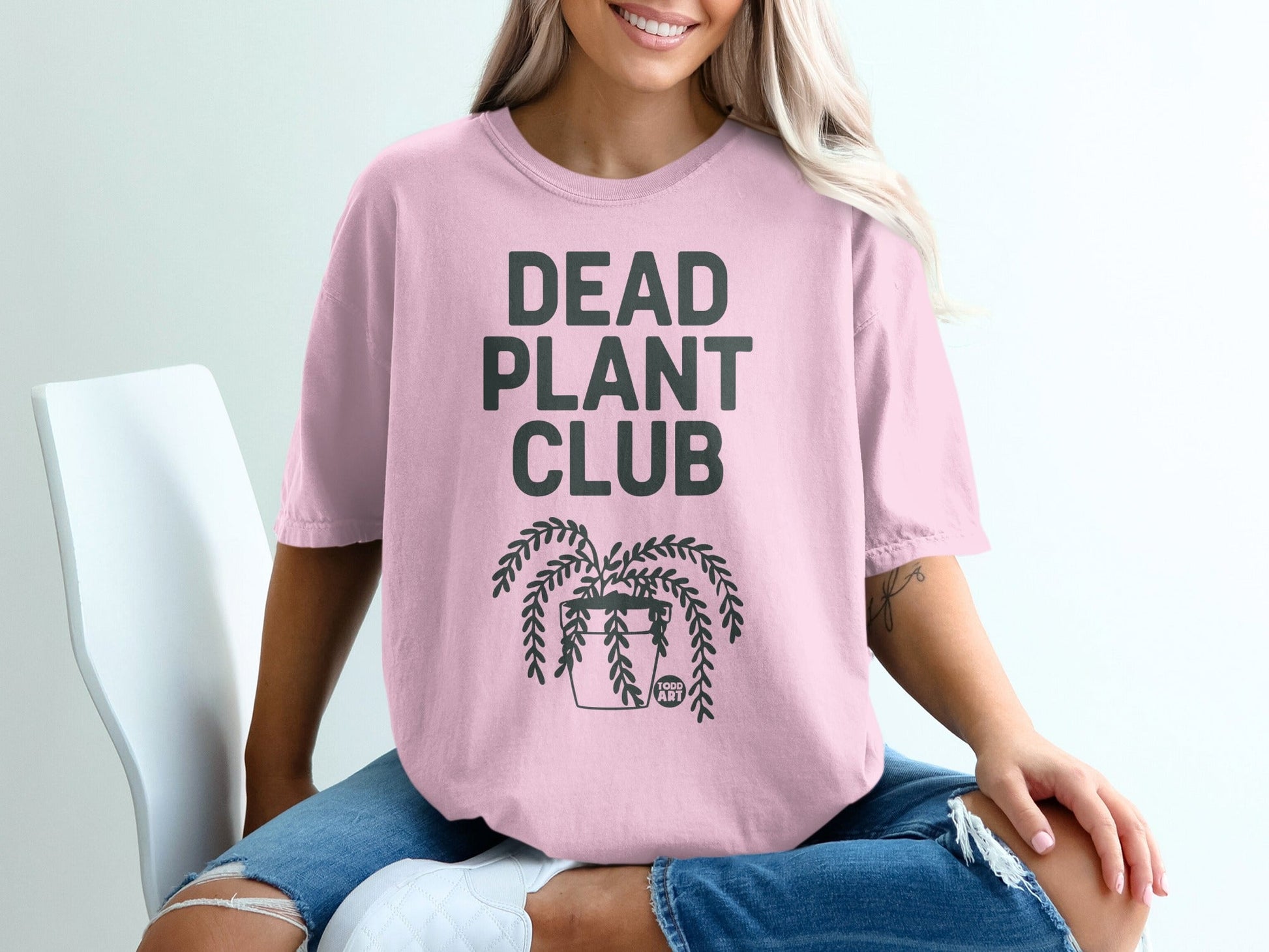 Pink t-shirt with "DEAD PLANT CLUB" and potted plant graphic.