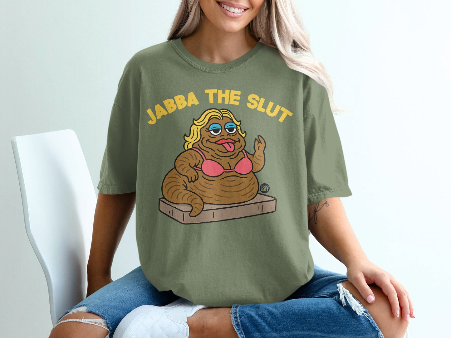 Olive green t-shirt with "JABBA THE SLUT" text and cartoon of Jabba the Hutt.