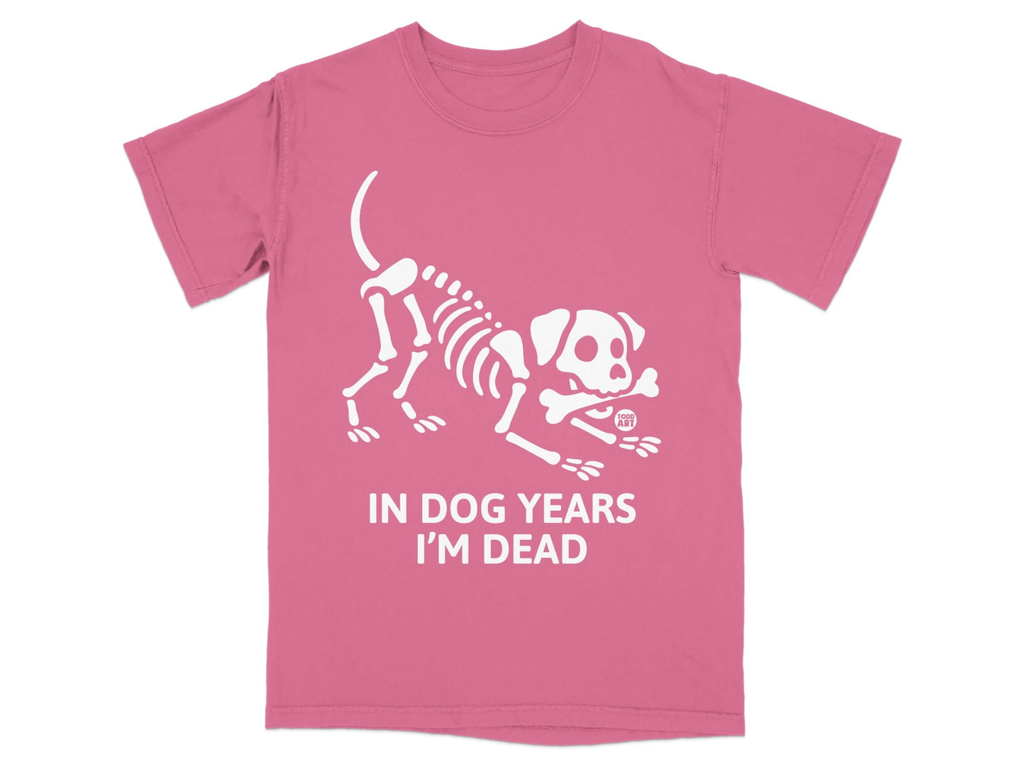 Pink t-shirt with white graphic of a dog skeleton holding a bone and text "IN DOG YEARS I'M DEAD".