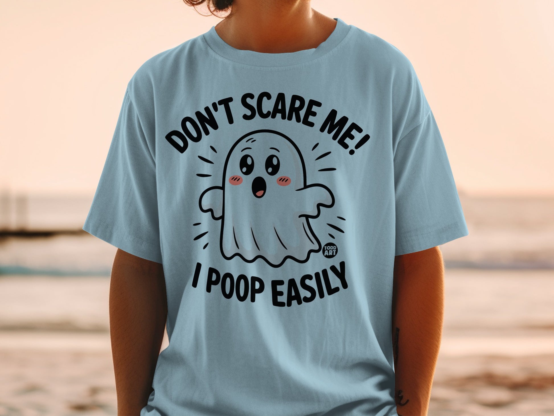Light blue t-shirt with ghost graphic and text "DON'T SCARE ME! I POOP EASILY."