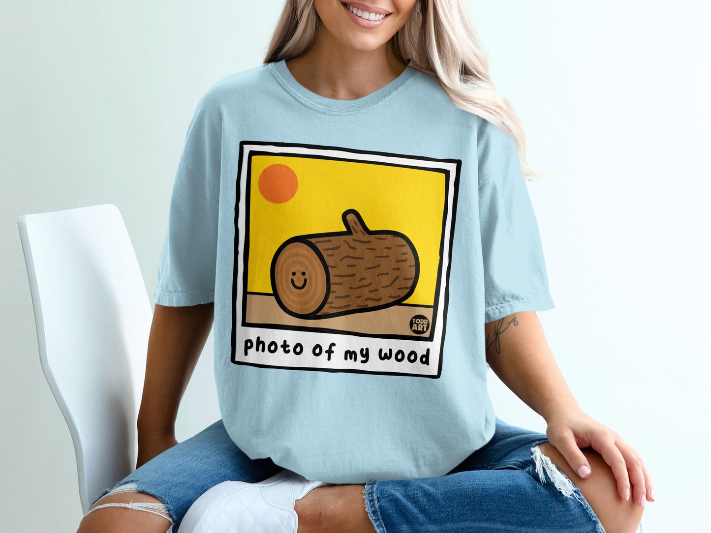 Light blue t-shirt with a cartoon log and "photo of my wood" text.