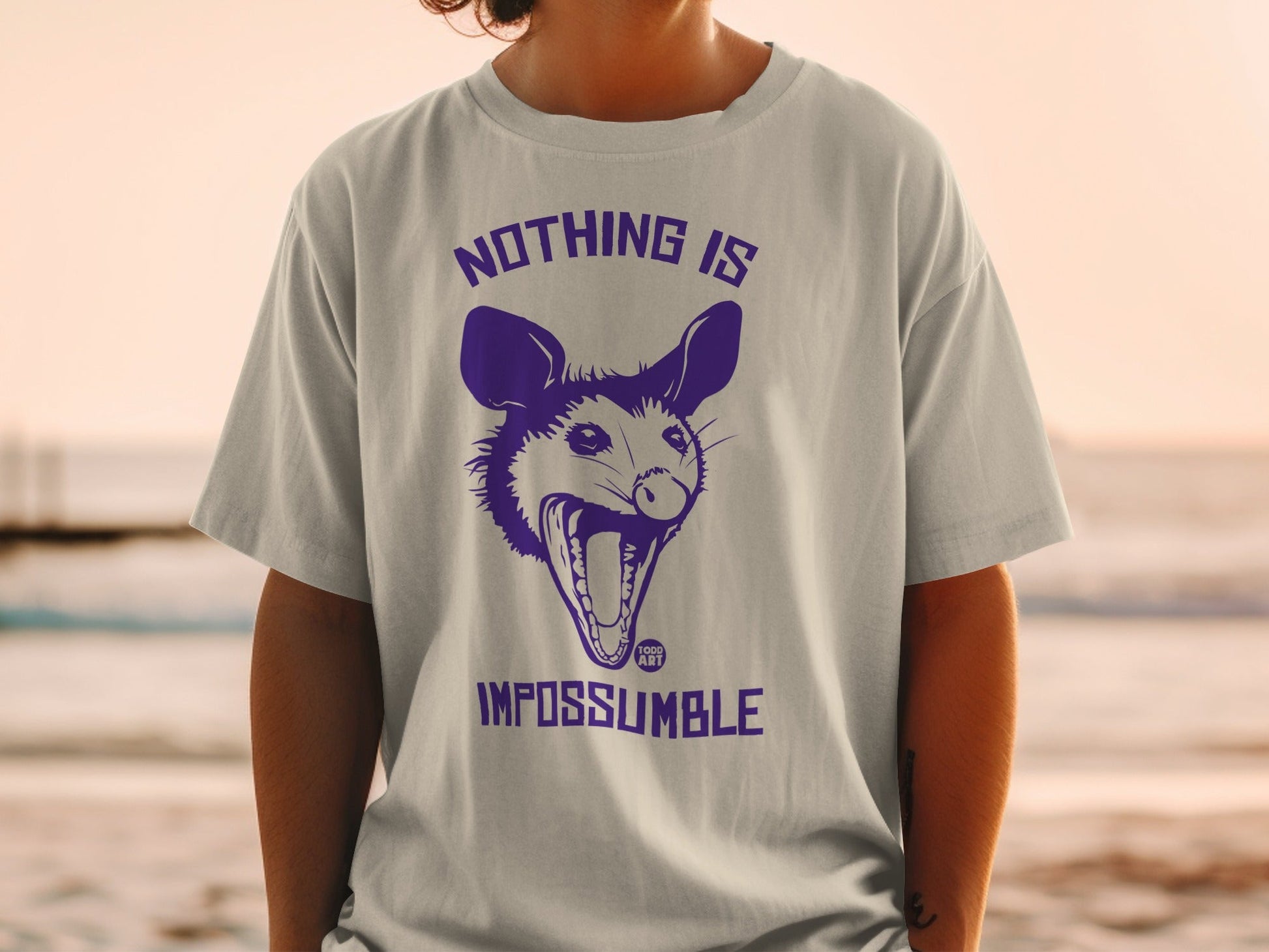 T-shirt with purple possum and text "NOTHING IS IMPOSSIBLE".