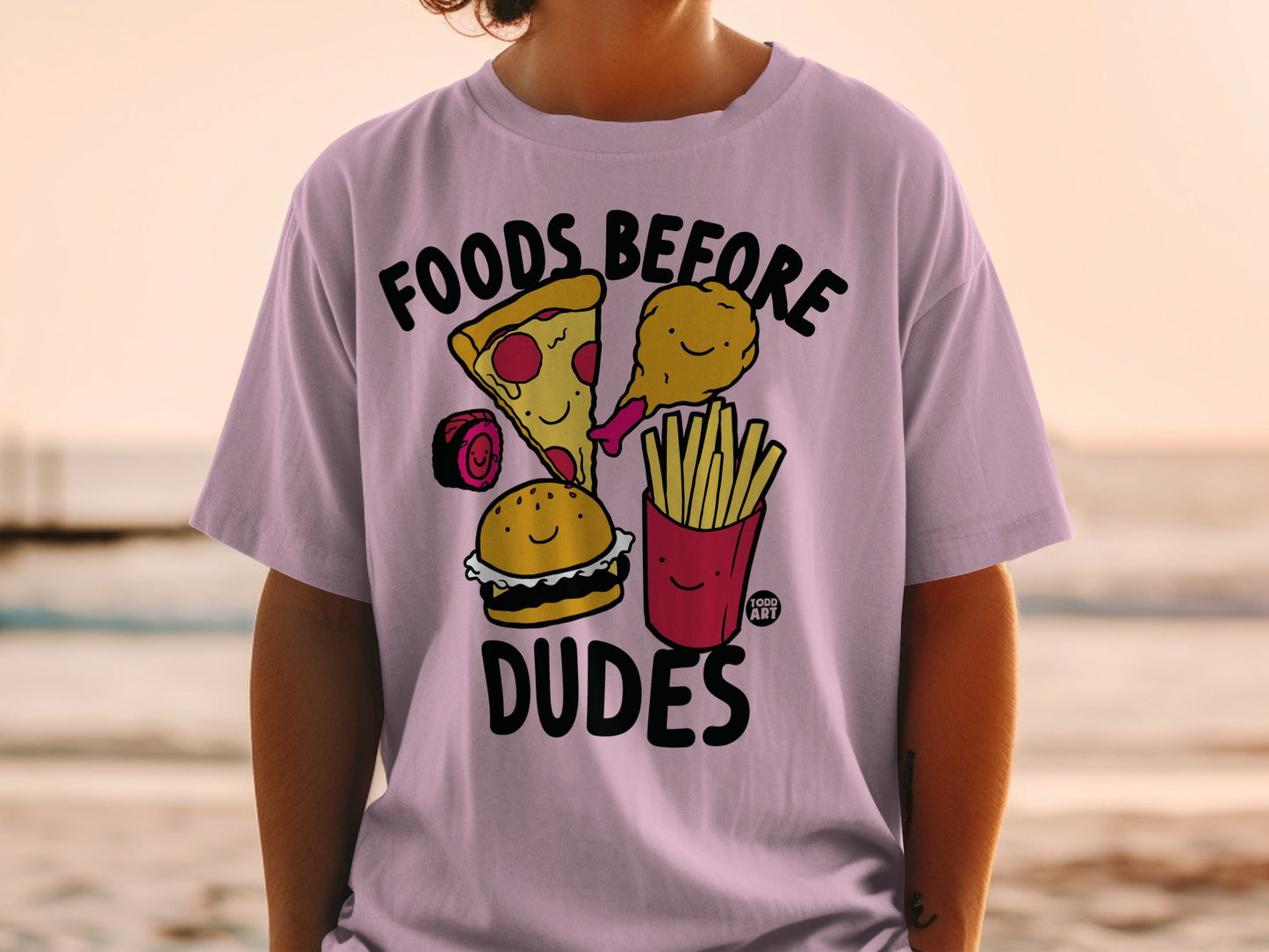 T-shirt with cartoon pizza, burger, chicken, and fries with "Foods Before Dudes" text.