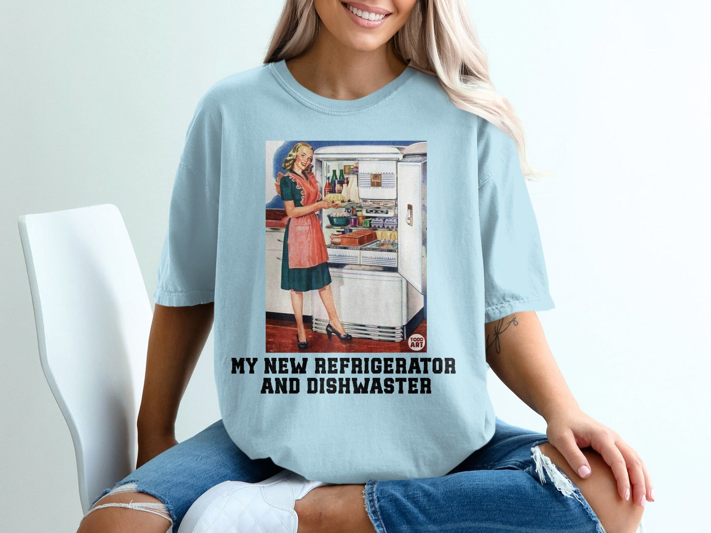 Light blue t-shirt with retro woman at refrigerator and text "My New Refrigerator and Dishwasher".