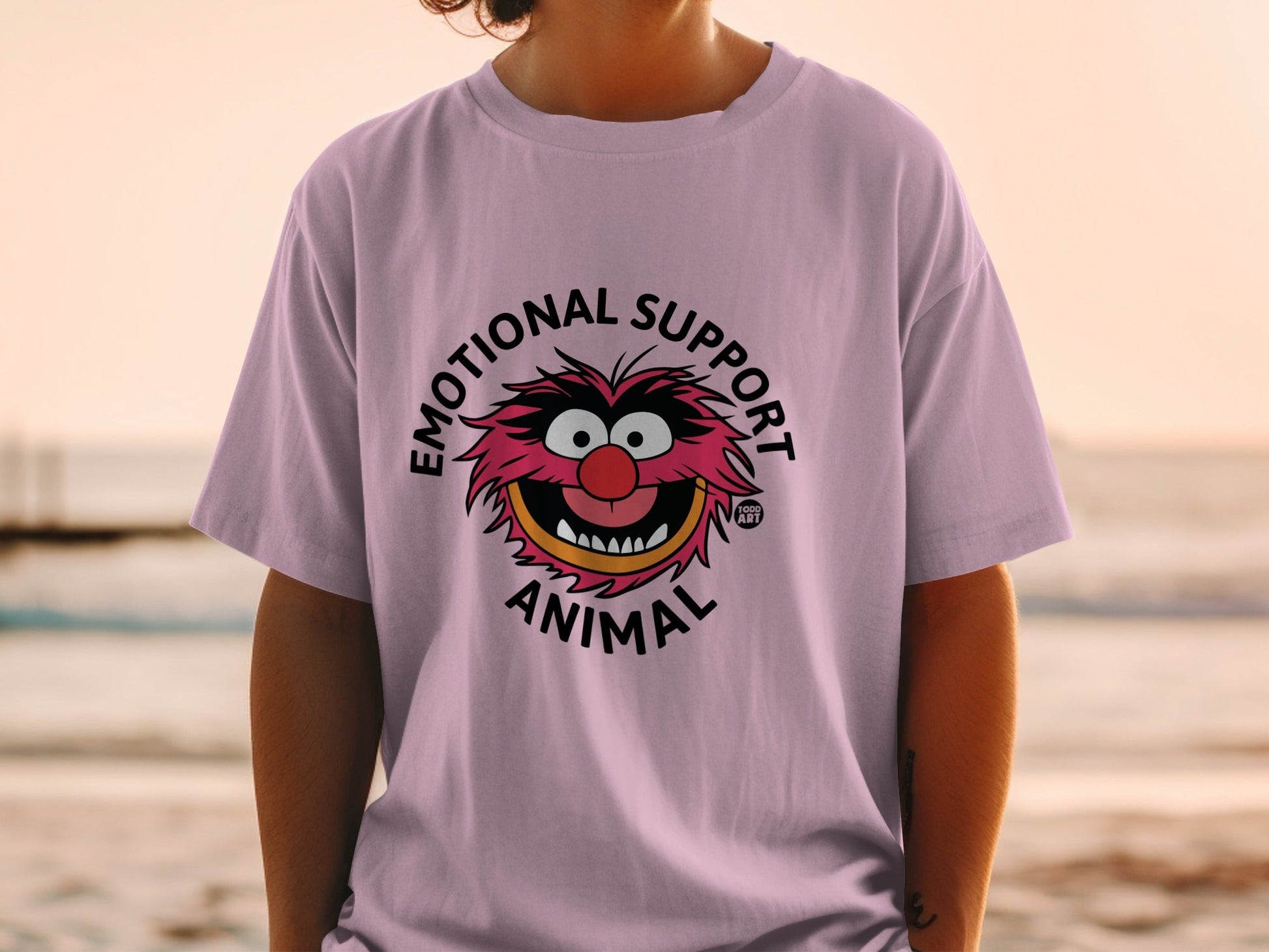 Pink t-shirt with "Emotional Support Animal" text and cartoon character.