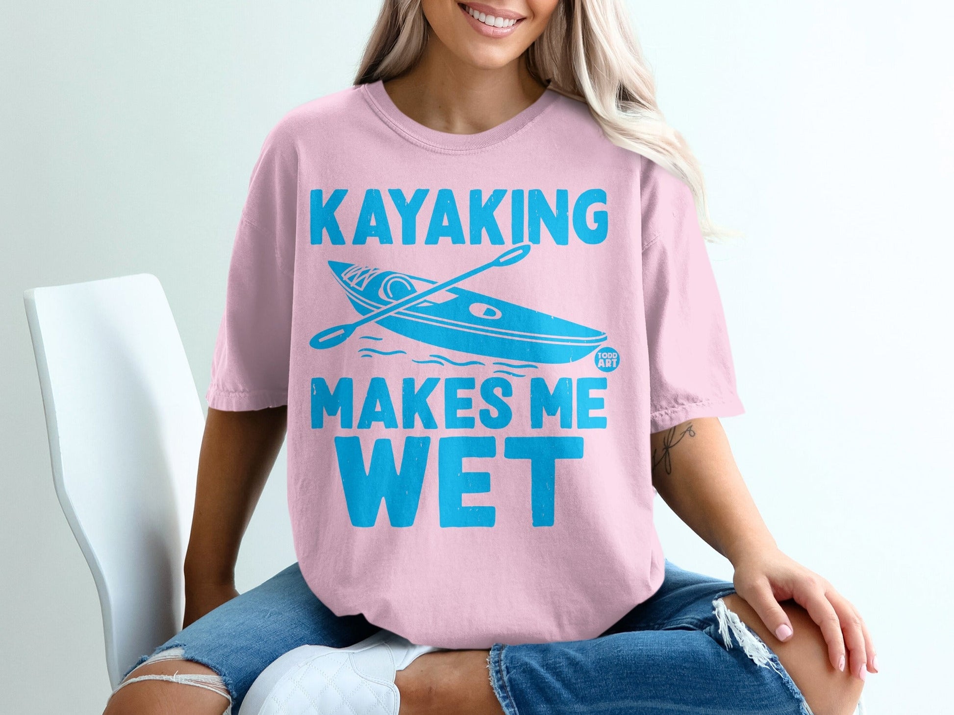 Pink t-shirt with "Kayaking Makes Me Wet" and a kayak illustration.