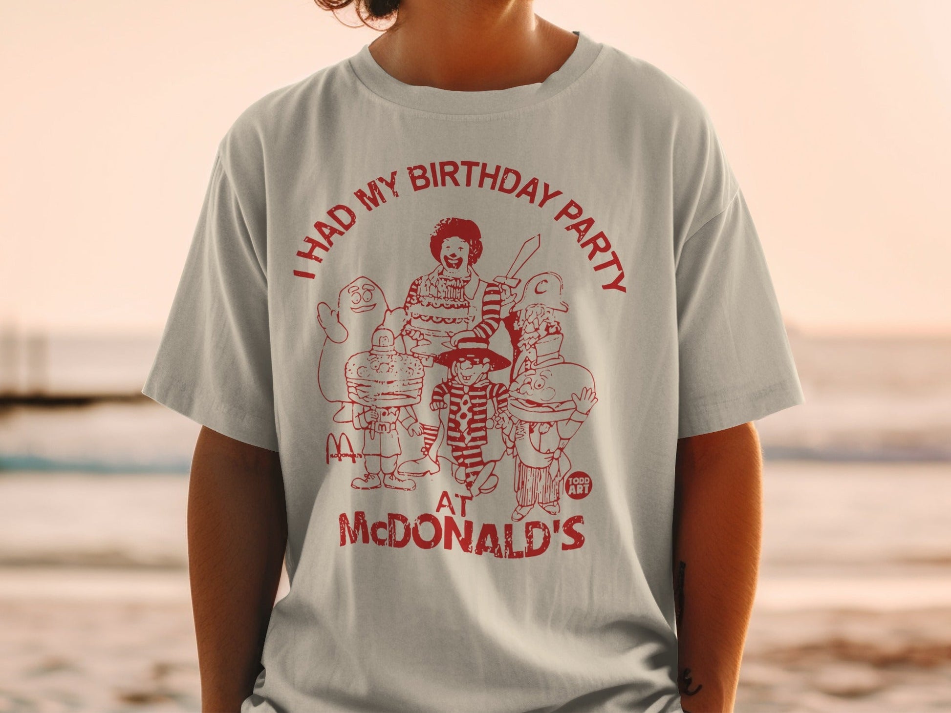 T-shirt with graphic of McDonald's characters and text "I HAD MY BIRTHDAY PARTY AT MCDONALD'S".