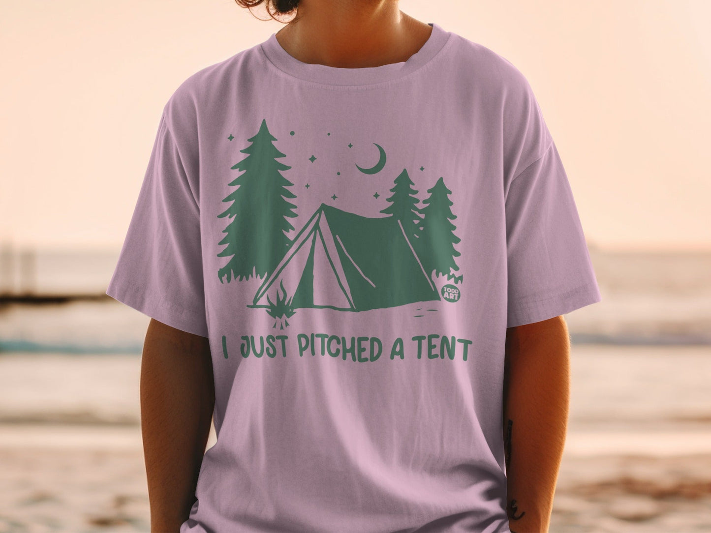 T-shirt with tent and trees graphic, reads "I JUST PITCHED A TENT".