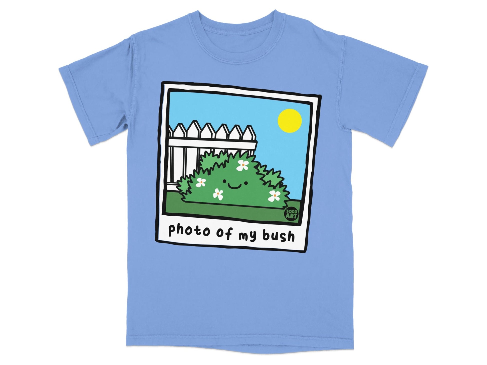 T-shirt with cartoon bush and fence illustration.