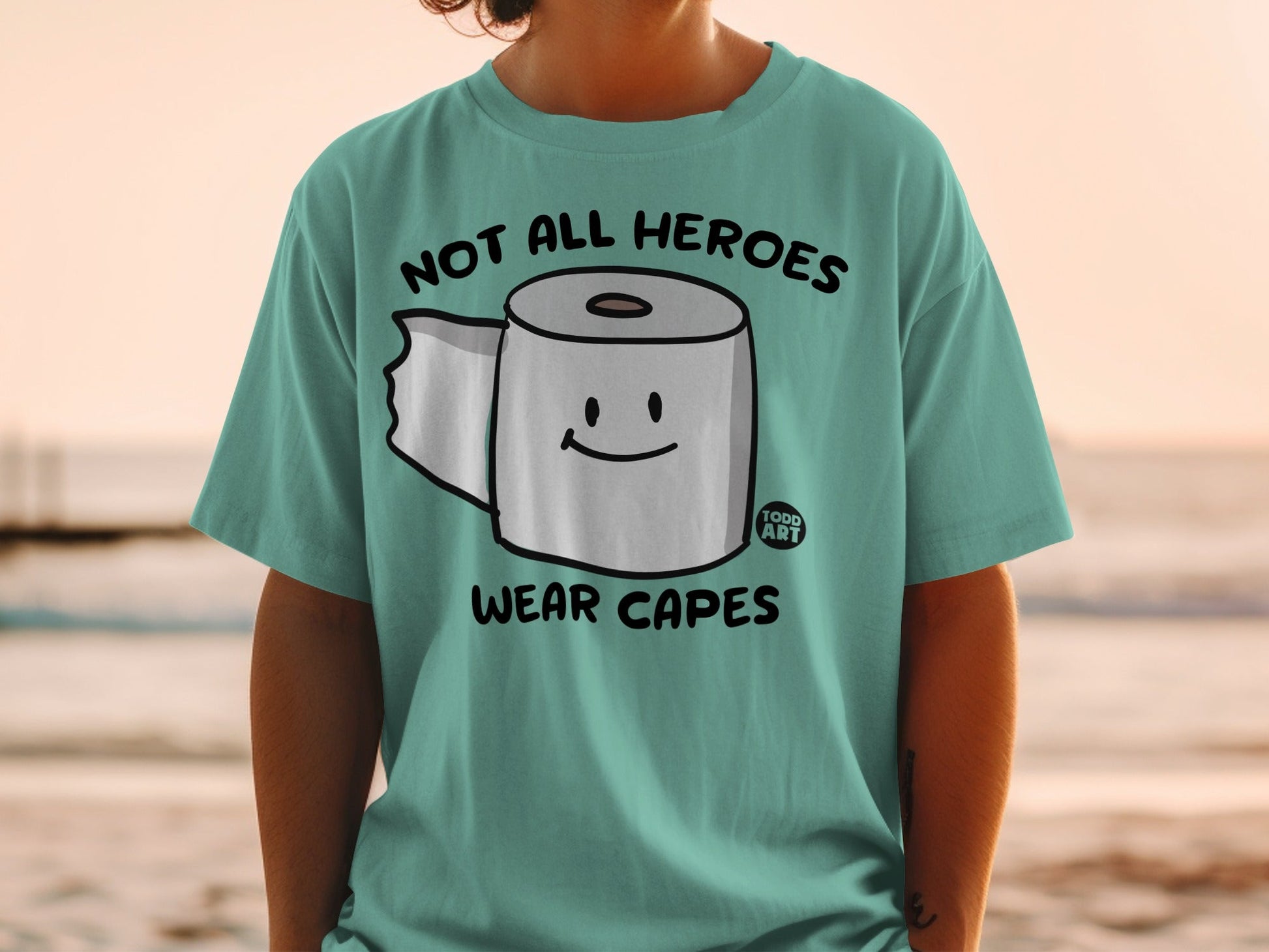 Toilet paper with smiling face and text "Not all heroes wear capes".