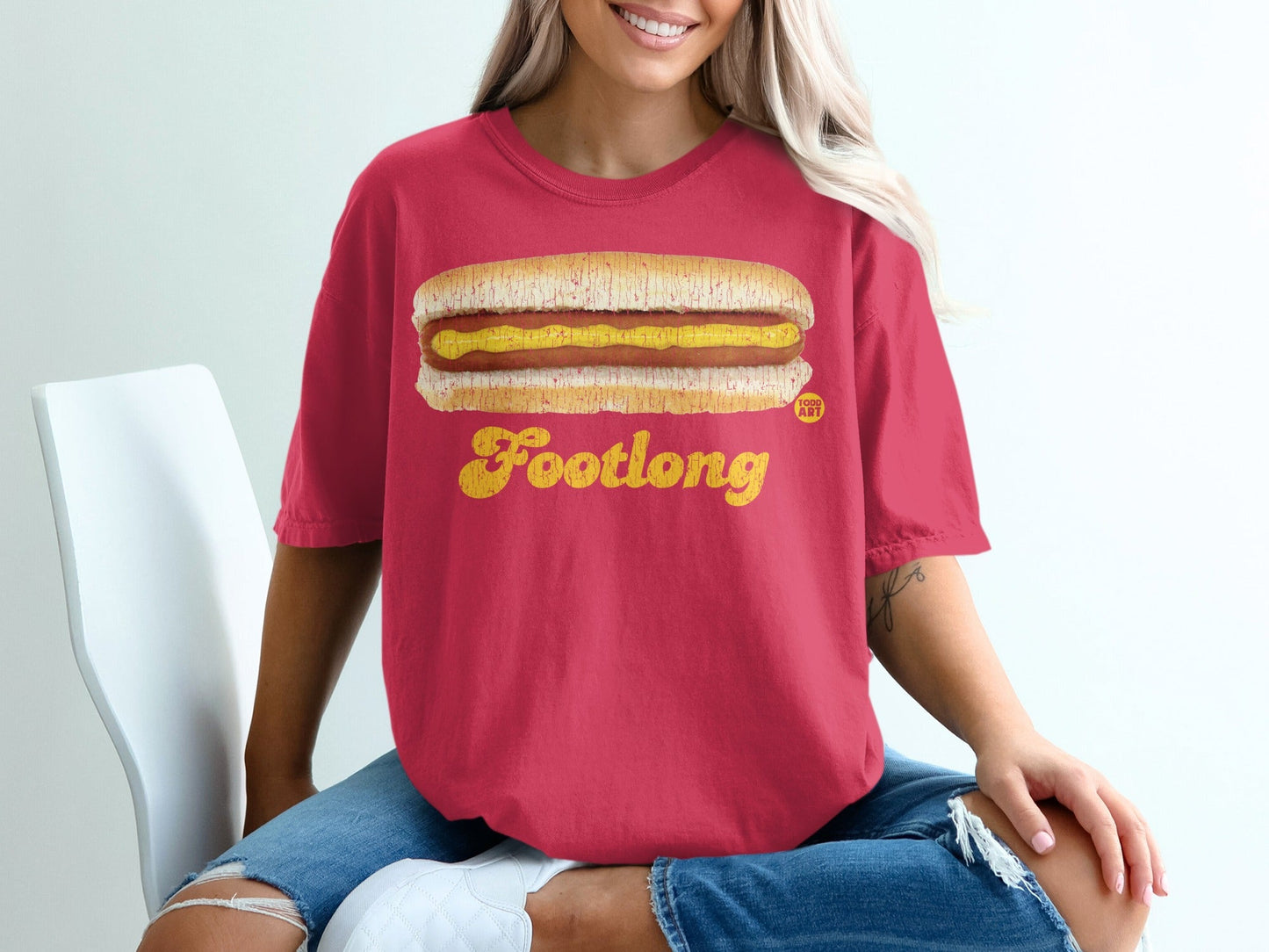 Red t-shirt with a "Footlong" hot dog graphic.