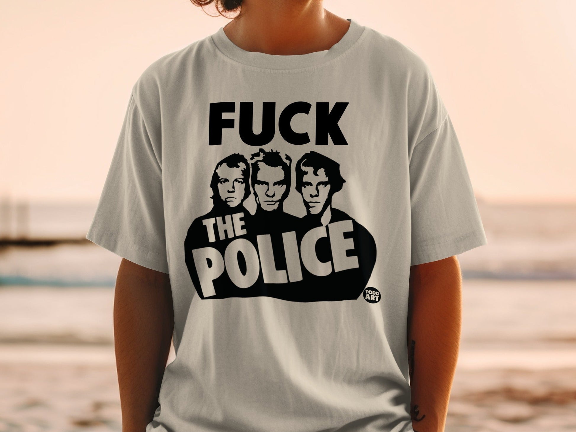 Light gray t-shirt featuring the text "FUCK THE POLICE" with three black and white portraits.