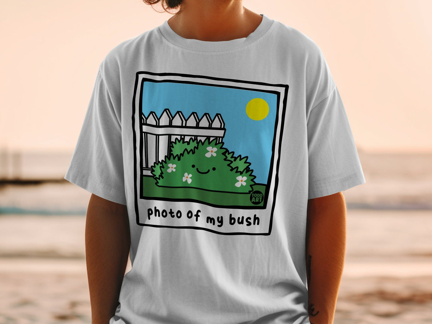 Cartoon bush with flowers and "photo of my bush" text on a t-shirt.