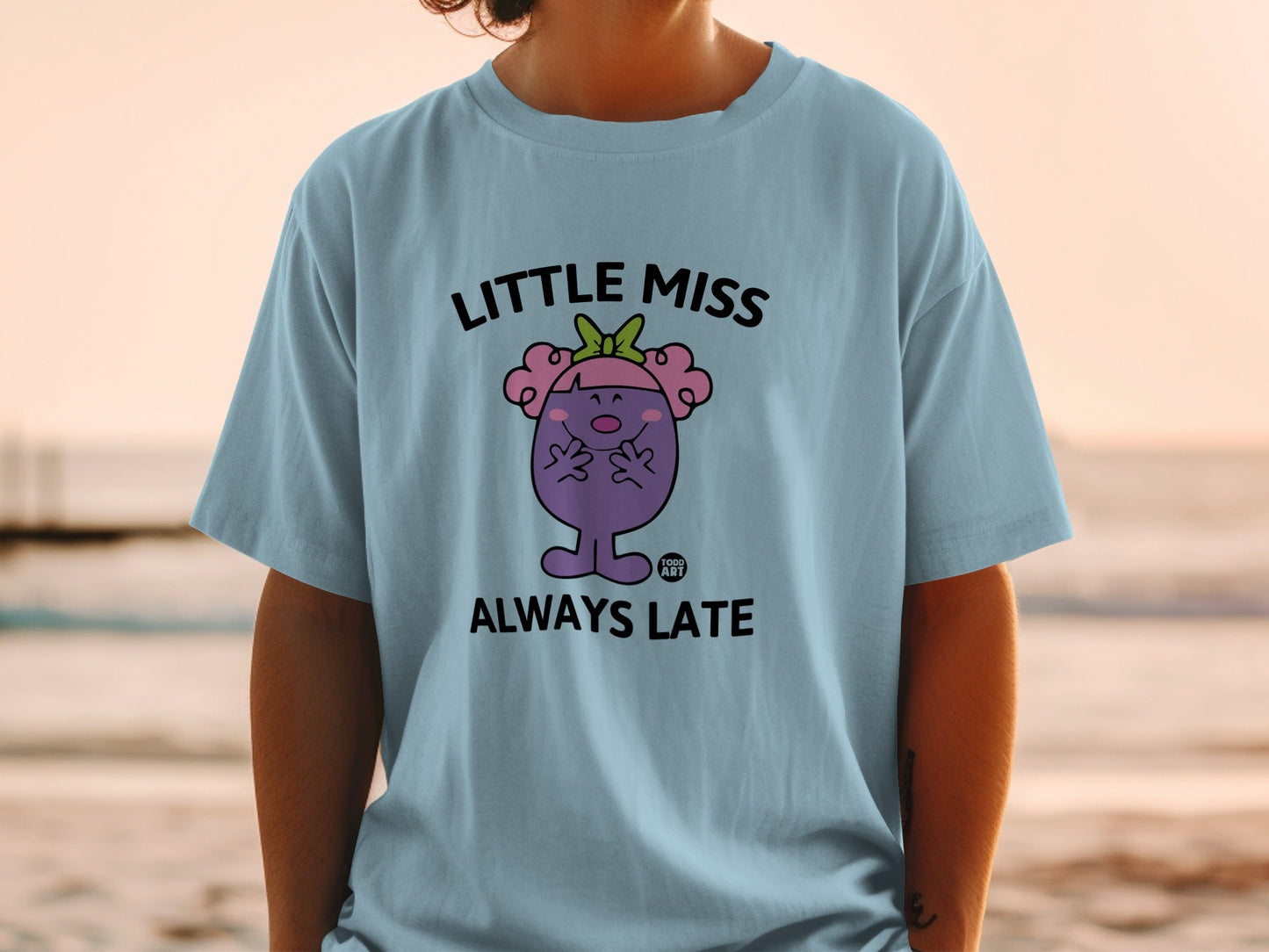 Light blue t-shirt with "Little Miss Always Late" cartoon character and text.