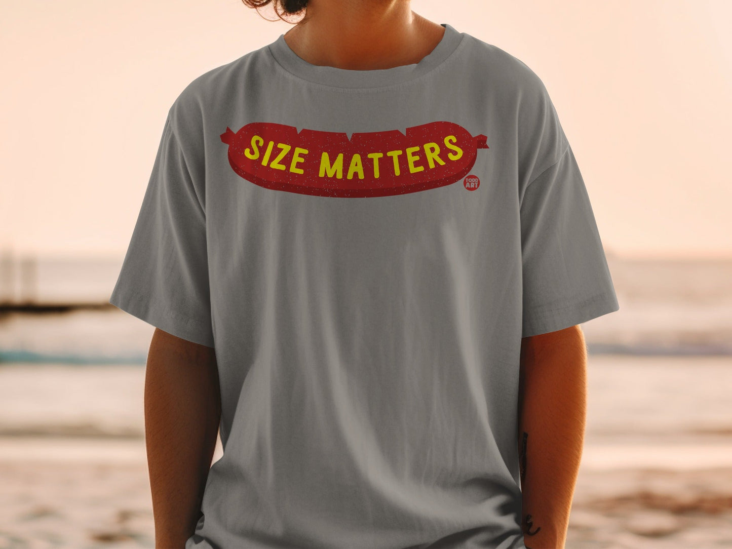 Grey t-shirt with a red cartoon sausage graphic and "SIZE MATTERS" text.