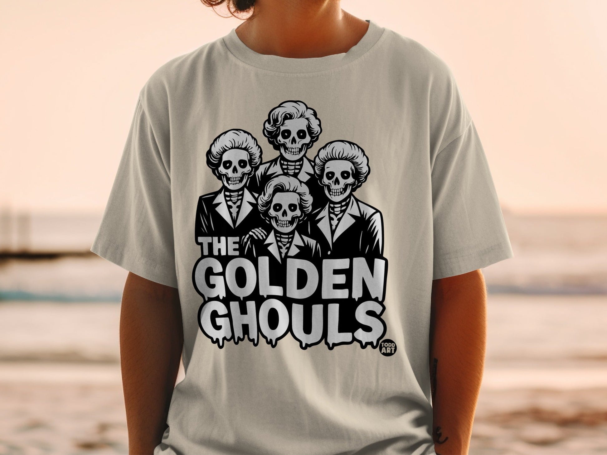 T-shirt with "The Golden Ghouls" text and four skull caricatures.