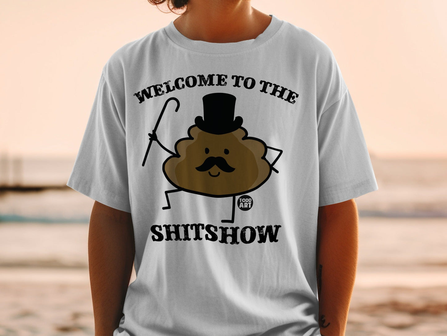 T-shirt with "Welcome to the Shitshow" text and a cartoon poop character.