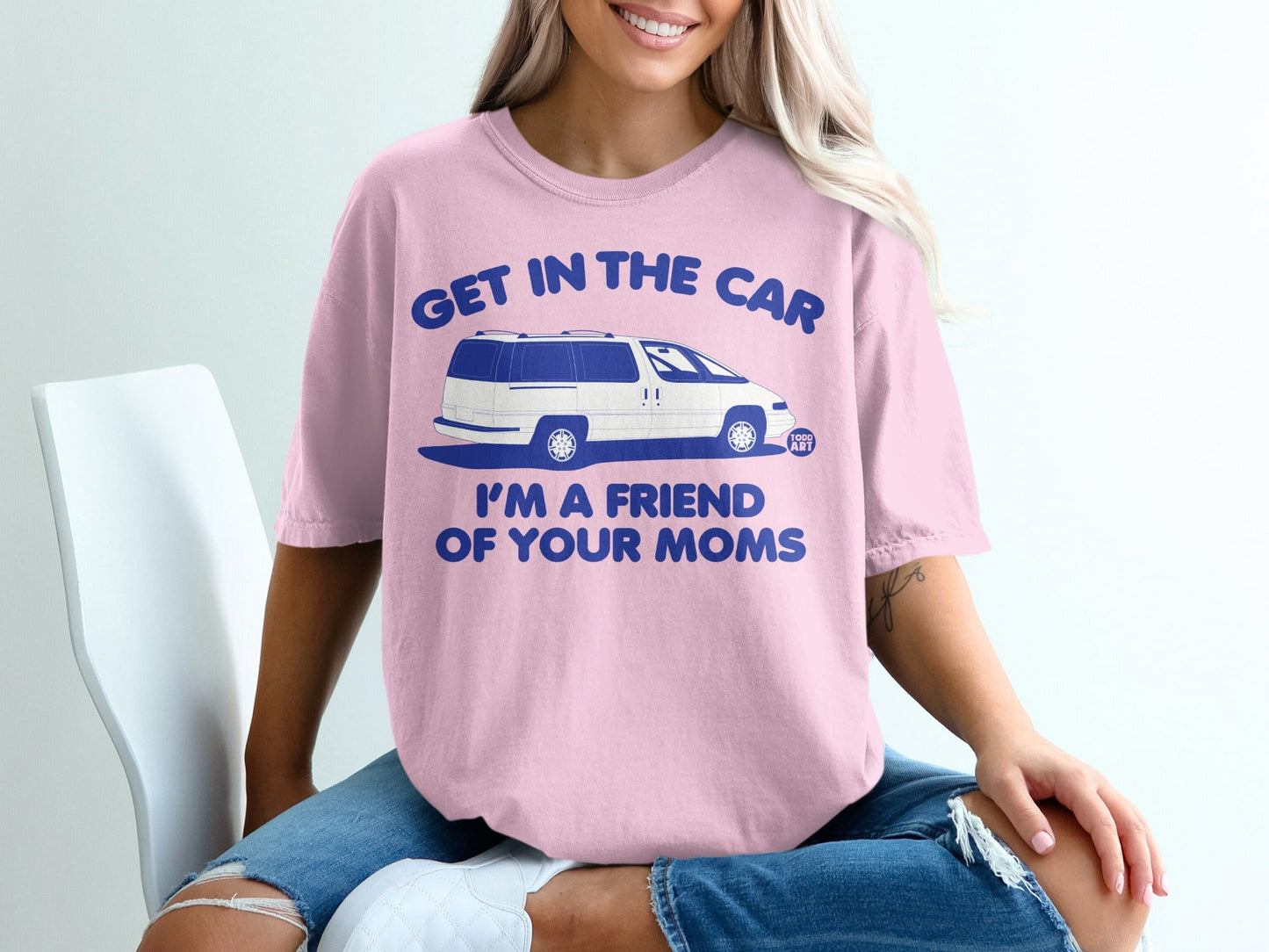 Pink t-shirt with blue text "GET IN THE CAR I'M A FRIEND OF YOUR MOMS" and a graphic of a van.