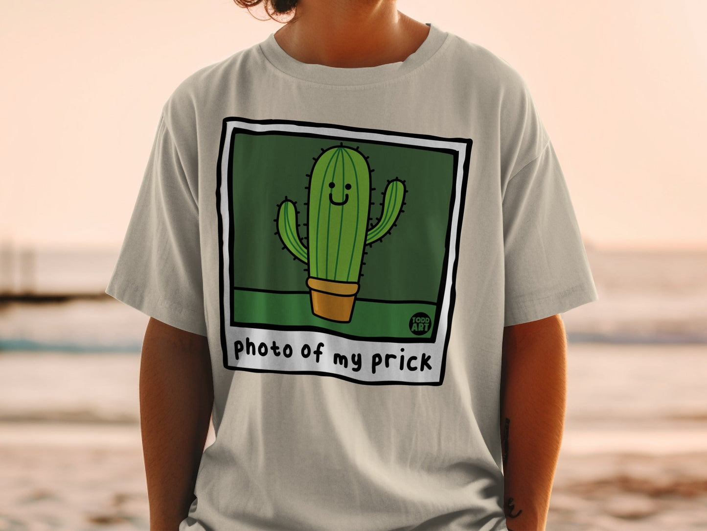 T-shirt with a cartoon cactus in a pot, saying "photo of my prick".