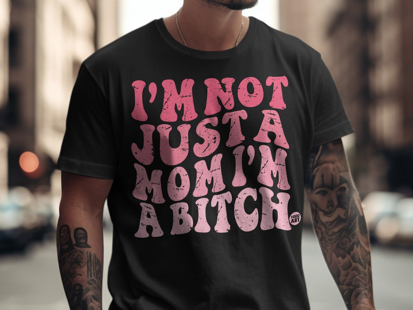 Black t-shirt with pink text reading "I'm not just a mom, I'm a bitch".