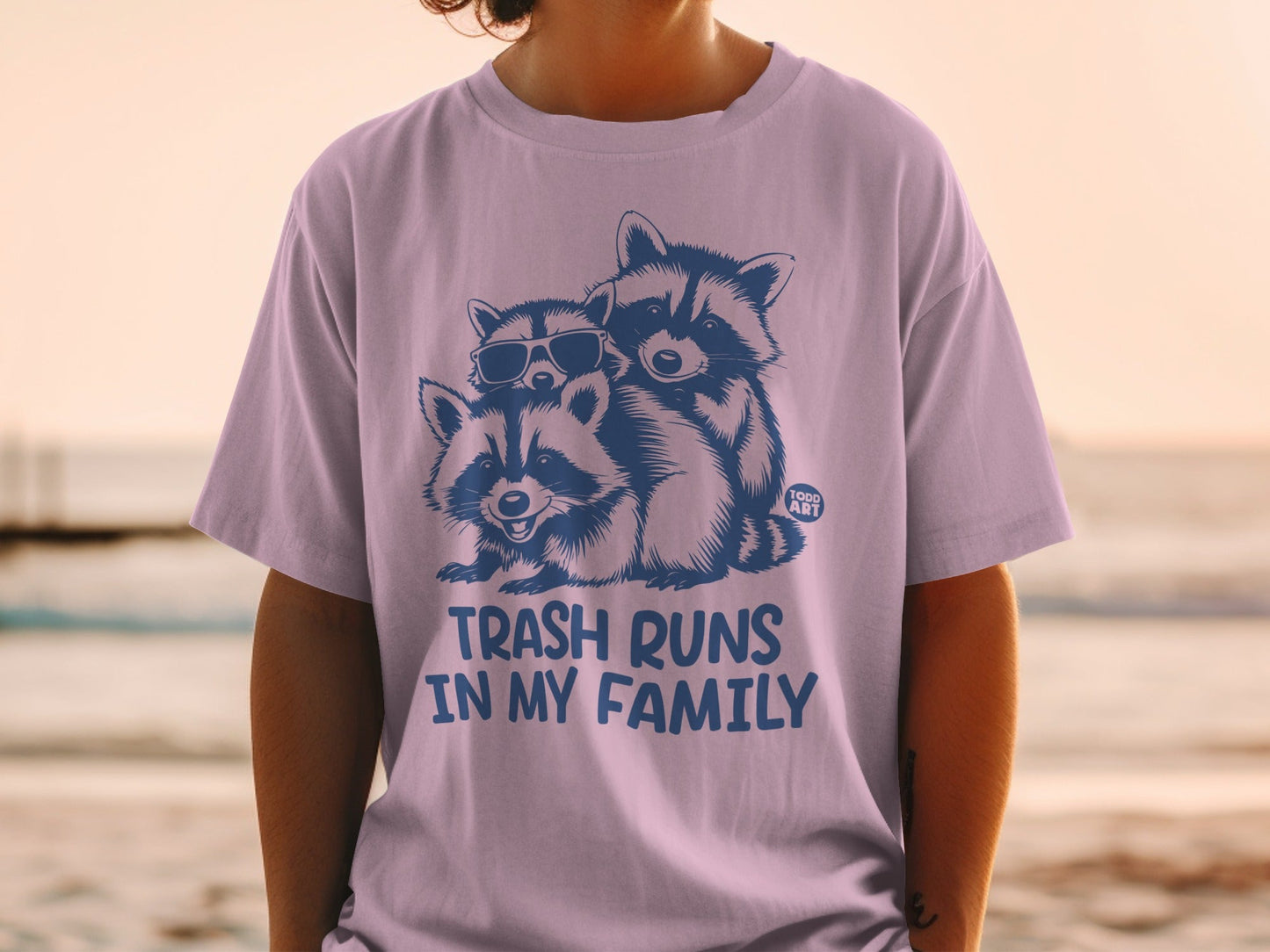 T-shirt with three raccoons wearing sunglasses and the text "Trash runs in my family".