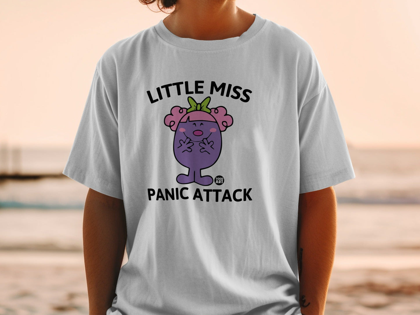 White t-shirt with "Little Miss PANIC ATTACK" cartoon character.