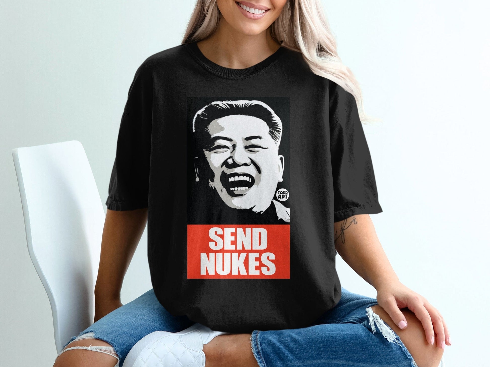 Black t-shirt with "SEND NUKES" and a laughing man's portrait.