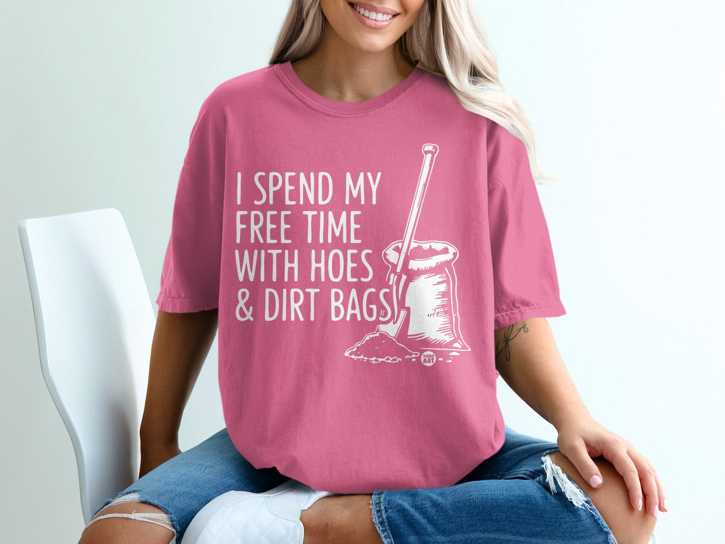 Pink t-shirt with white text "I SPEND MY FREE TIME WITH HOES & DIRT BAGS" and shovel graphic.