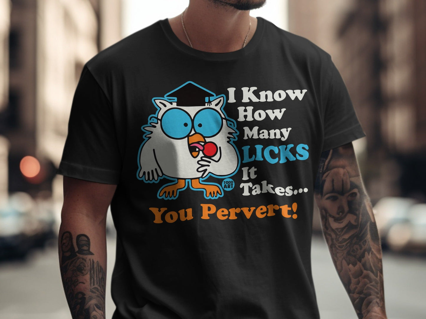 T-shirt with a cartoon owl wearing a graduation cap, holding a lollipop.