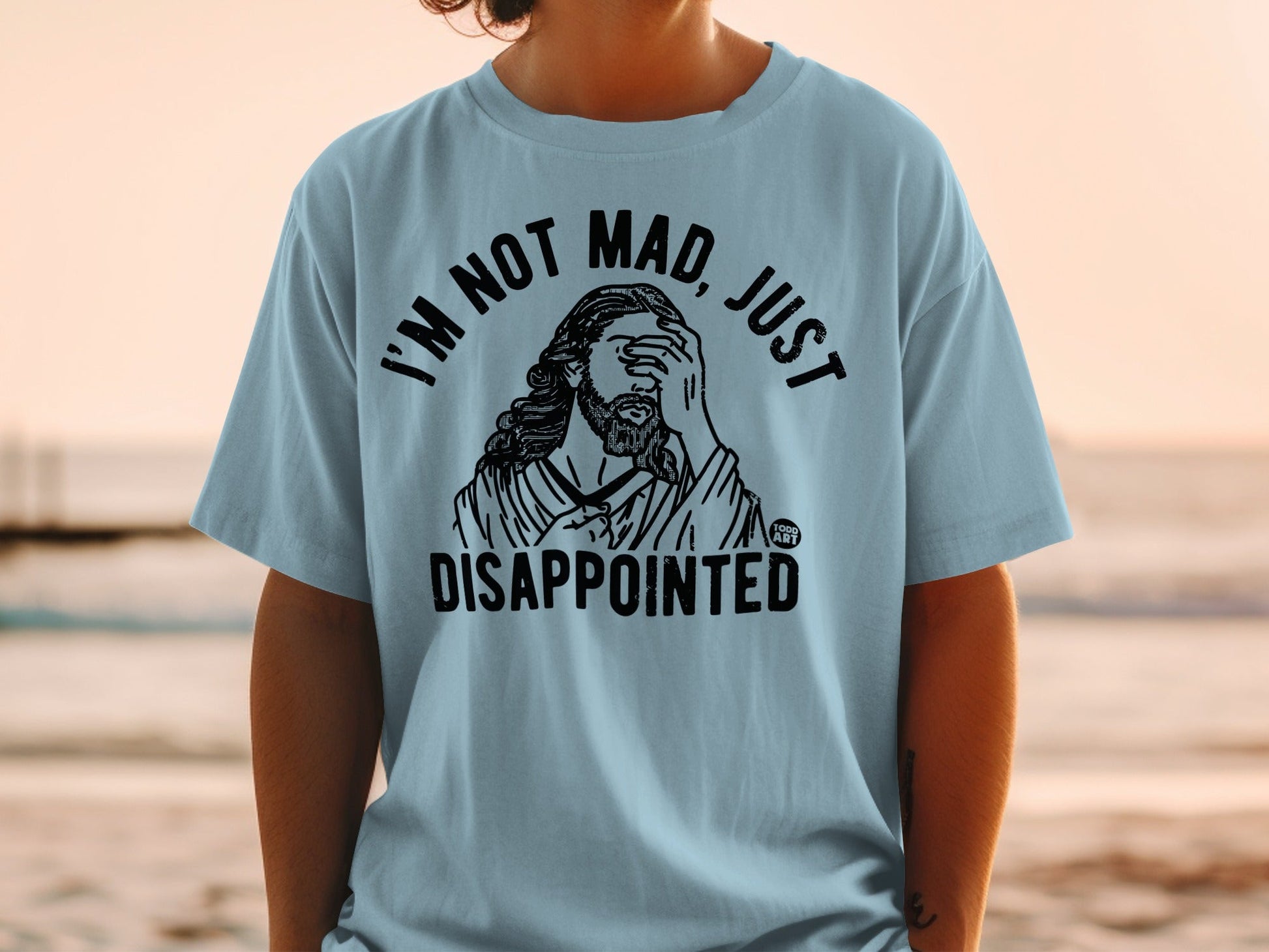 Light blue t-shirt with black text and Jesus graphic, "I'm not mad, just disappointed."