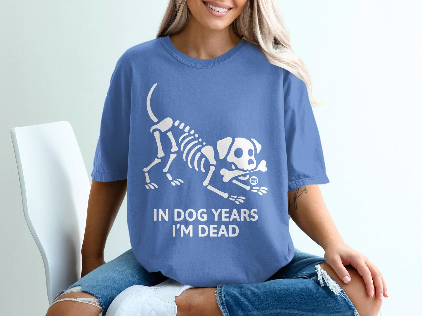 Blue t-shirt with a white dog skeleton graphic and text "IN DOG YEARS I'M DEAD".
