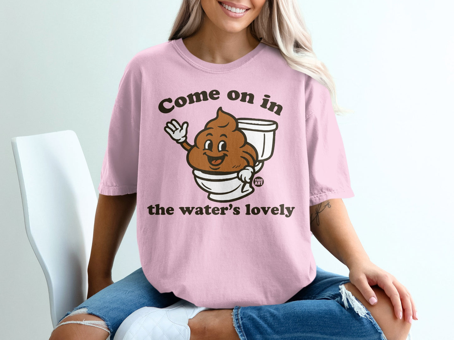 Pink t-shirt with cartoon toilet paper roll and text "Come on in the water's lovely."