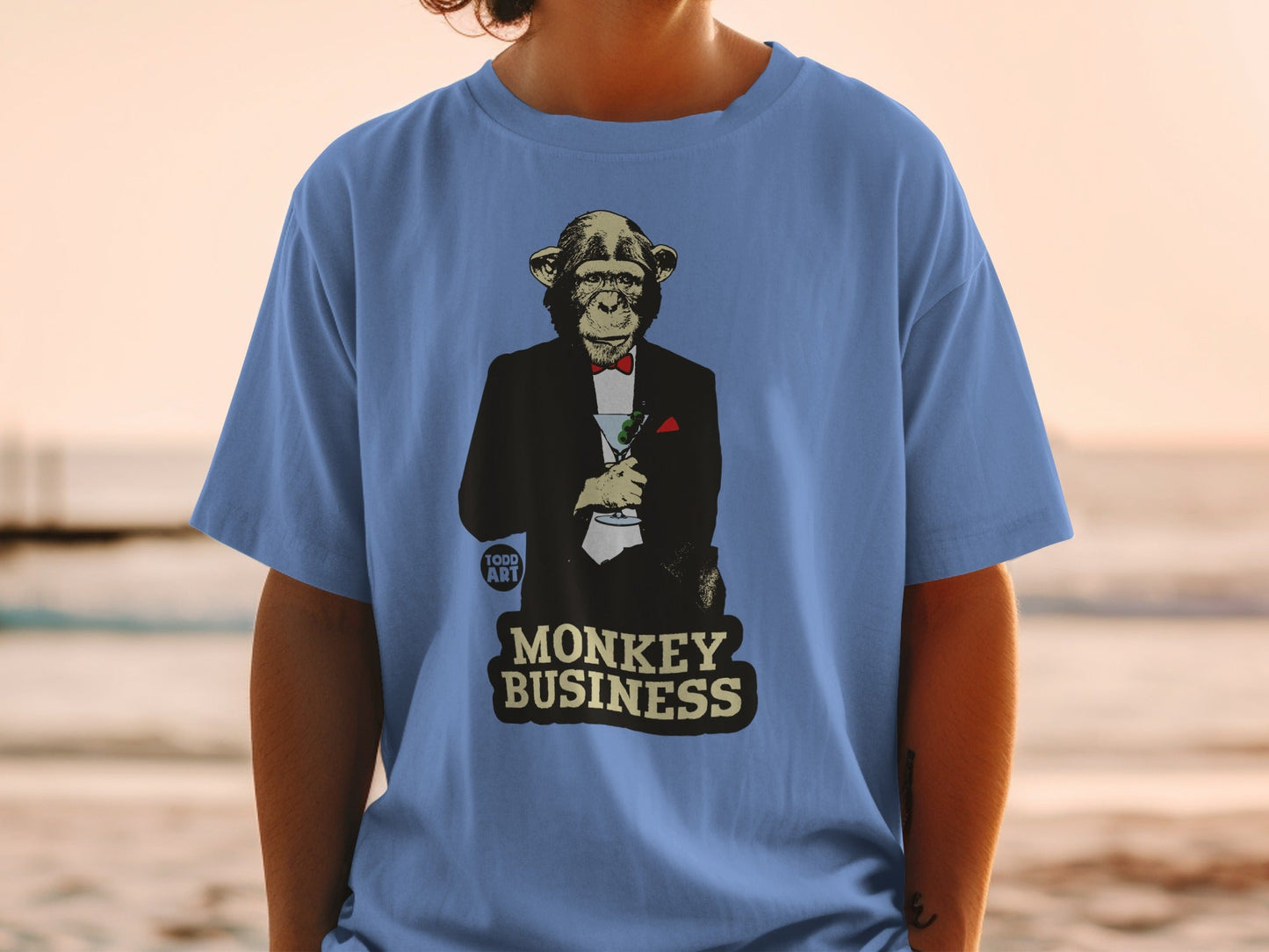 T-shirt with monkey in tuxedo holding martini, "MONKEY BUSINESS" text.