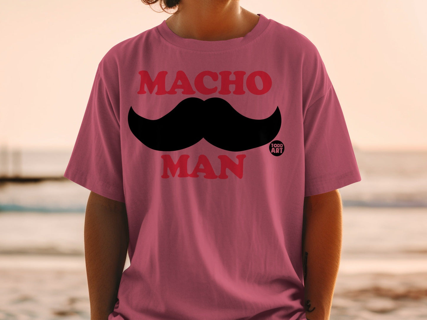 Pink t-shirt with black mustache graphic and "Macho Man" text.
