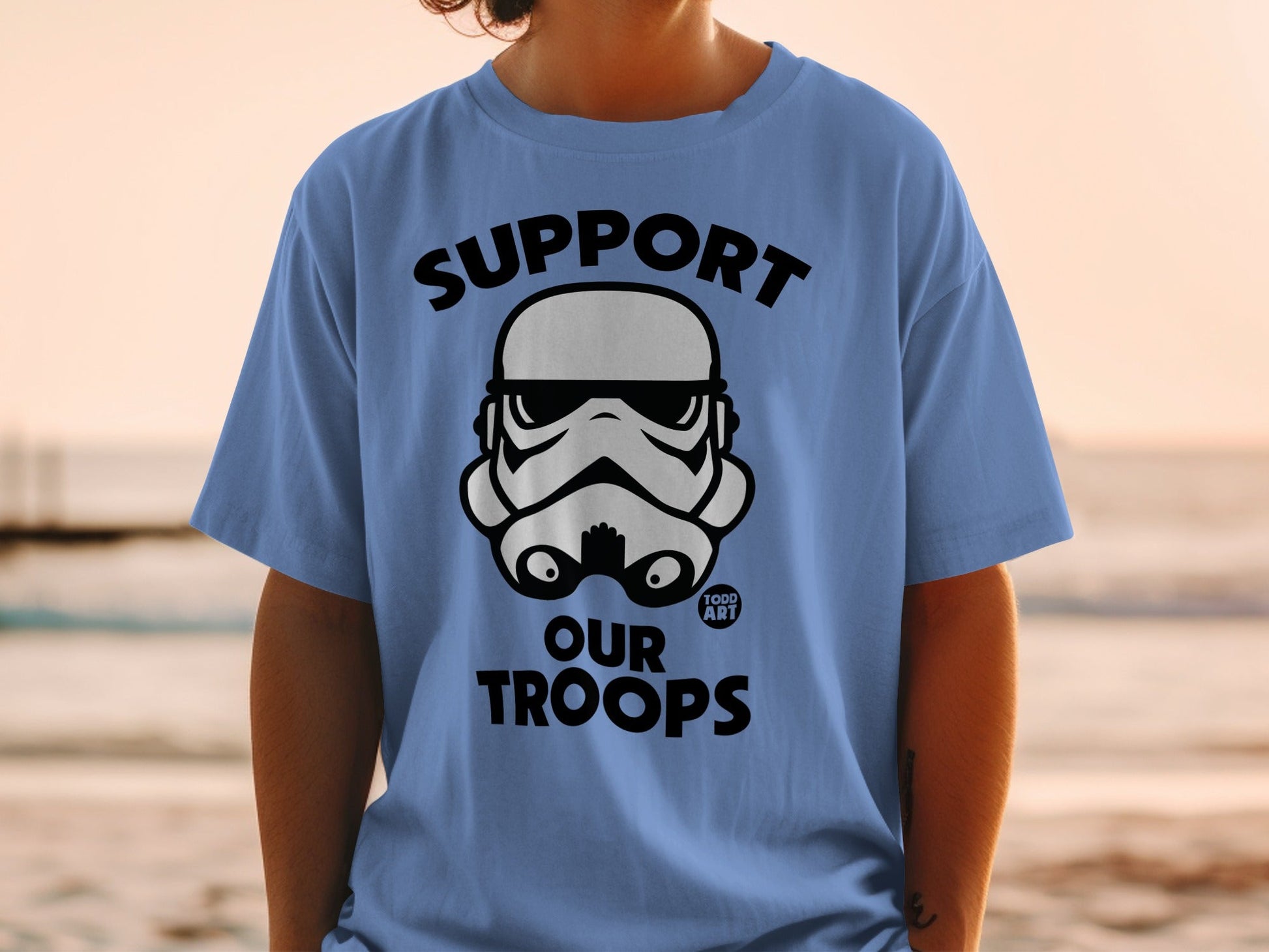 Blue t-shirt with white Stormtrooper helmet and "SUPPORT OUR TROOPS" text.