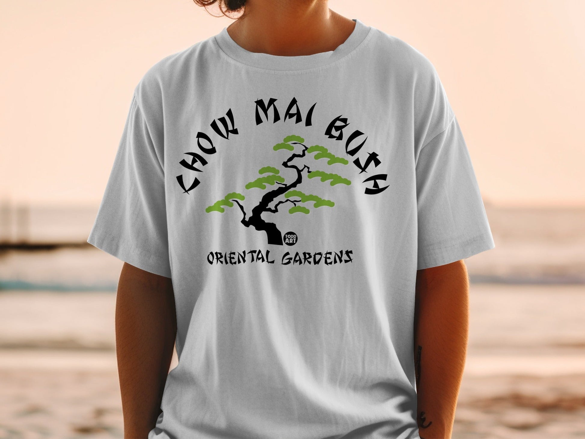 White t-shirt with "CHOW MAI BUSH" and a stylized tree graphic.