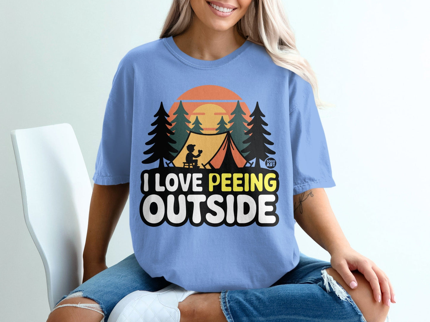 T-shirt with "I LOVE PEeing OUTSIDE" text and camping graphic.