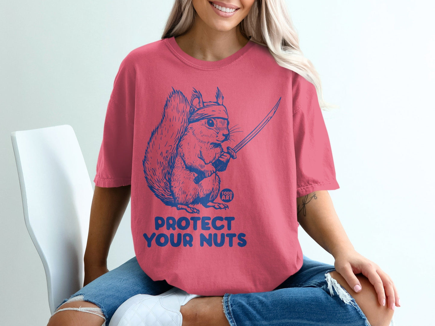 Squirrel with sword and bandana, "PROTECT YOUR NUTS" text.
