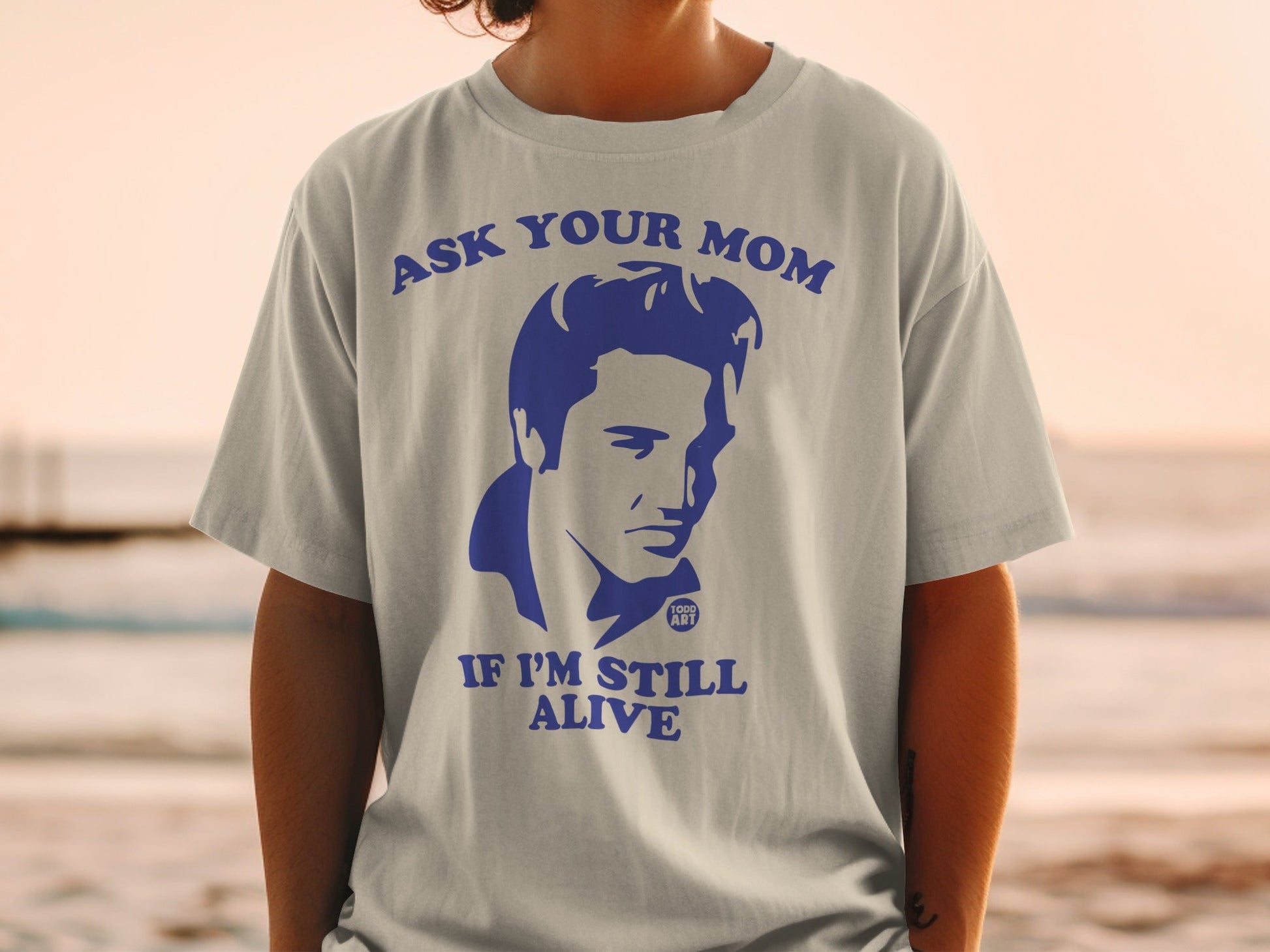 T-shirt with "Ask Your Mom If I'm Still Alive" and Elvis Presley portrait.