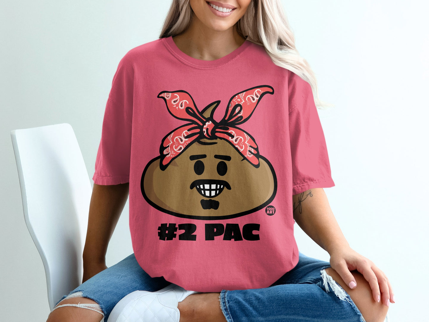 Pink t-shirt with a cartoon face wearing a red bandana, labeled "#2 PAC".