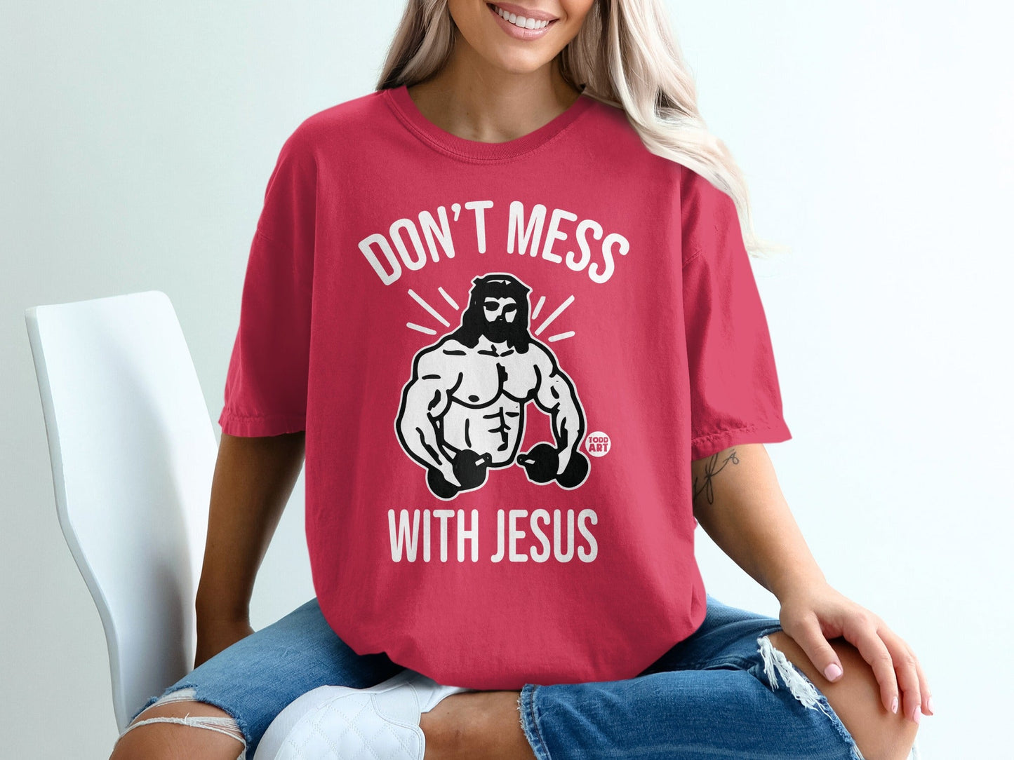 Red t-shirt with white text "DON'T MESS WITH JESUS" and a muscular Jesus graphic.